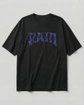 A black short-sleeve crewneck t-shirt featuring a stylized 'RATM' graphic across the chest in a purple and blue zebra-like pattern, displayed against a neutral light gray background.