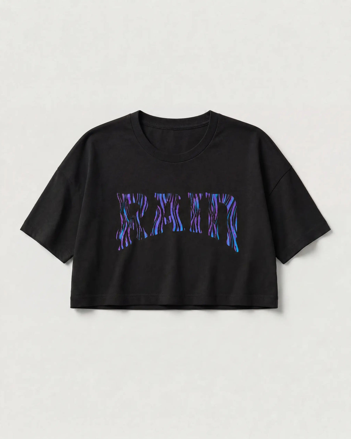 A black short-sleeve cropped T-shirt with a stylized 'MADISON' graphic across the chest in a purple and blue flame-like pattern, displayed against a light gray background.