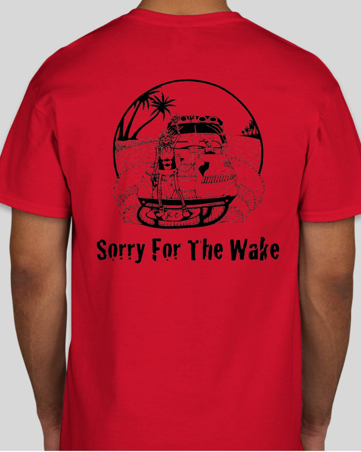 A red short-sleeve t-shirt shown from the back on a model, featuring a black graphic of a pirate ship on a tropical island with the text 'Sorry For The Wake'.