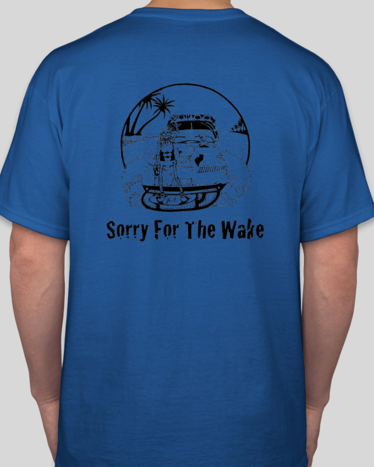 A man wearing a royal blue t-shirt, viewed from the back. The shirt features a black graphic of a vintage car on a boat with palm trees and the text 'Sorry For The Wake' printed below it.