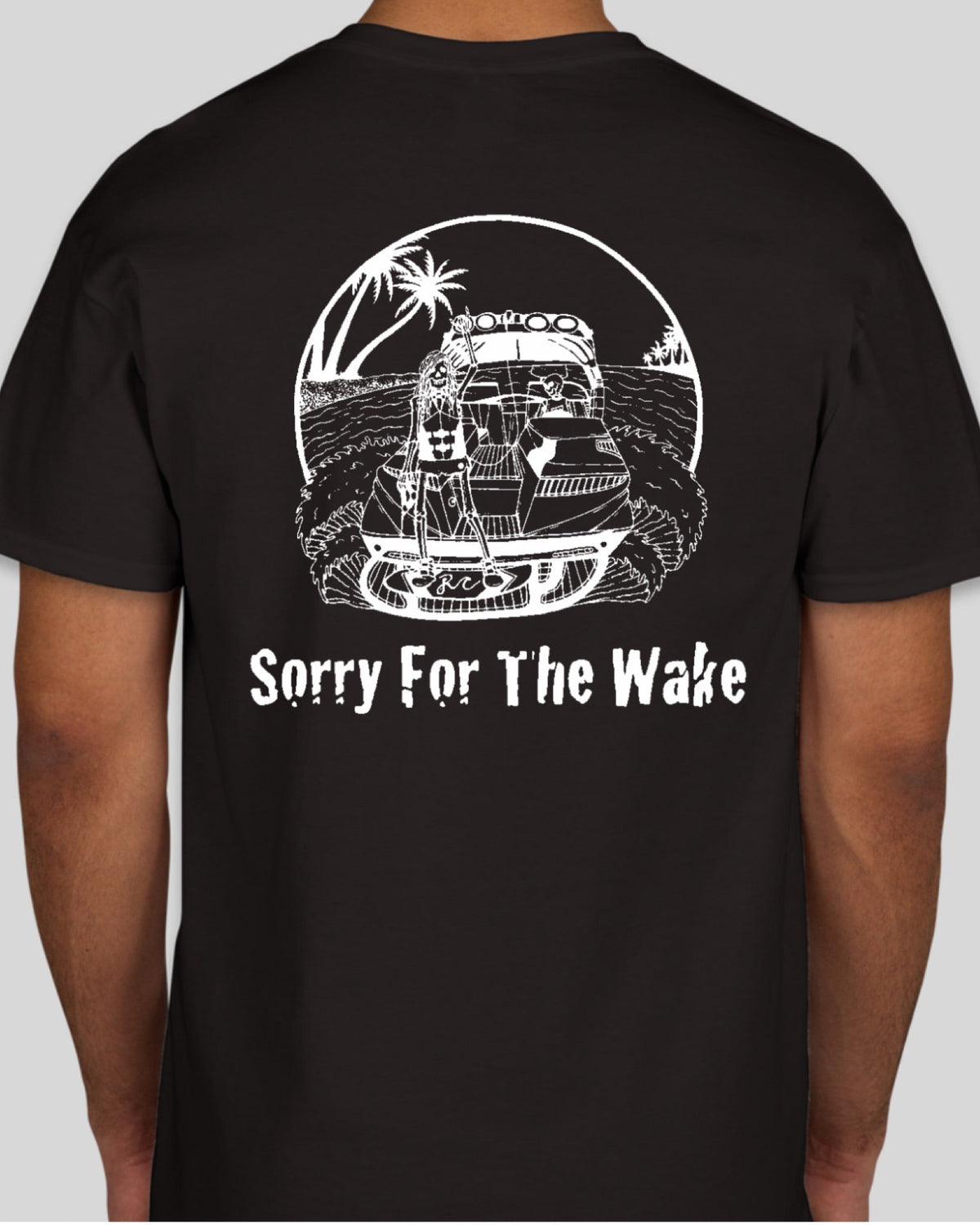 A man wearing a black t-shirt, viewed from the back. The shirt features a white graphic of a vintage pickup truck with a palm tree and the text 'Sorry For The Wake' printed below it.